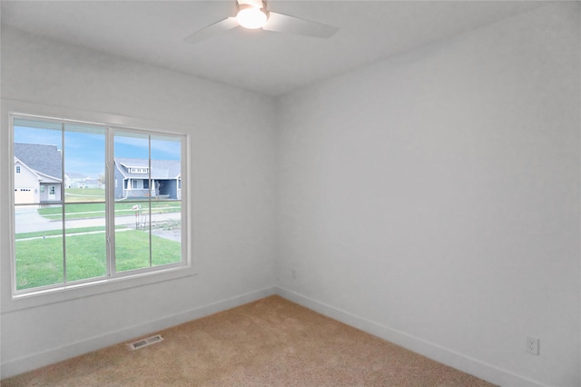 carpeted empty room featuring ceiling fan