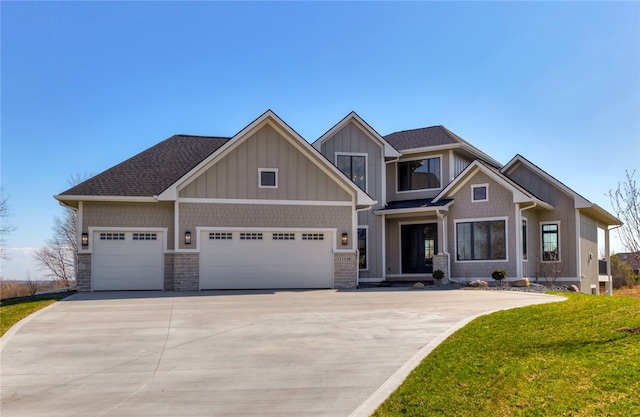 craftsman house featuring a front yard and a garage