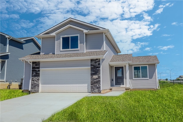 view of front of home with a front yard and a garage