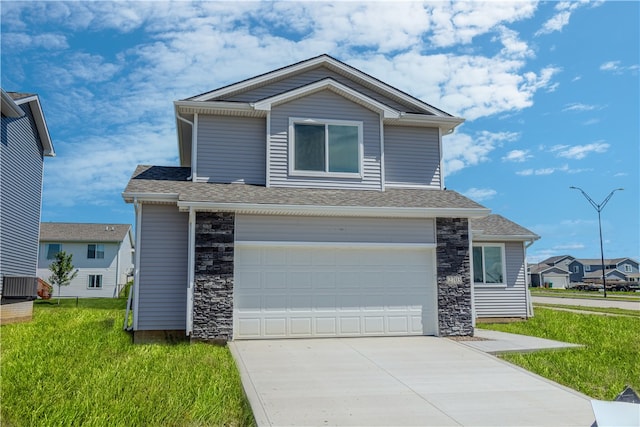 view of front of house with a garage and a front lawn