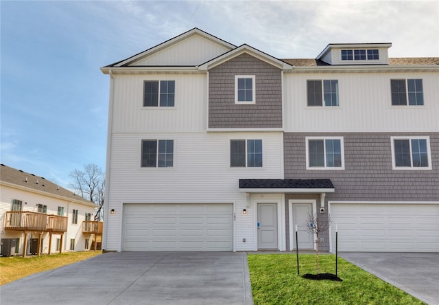 view of front of property featuring a garage and central AC unit