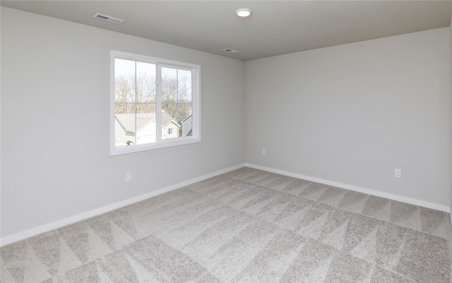 spare room with light colored carpet