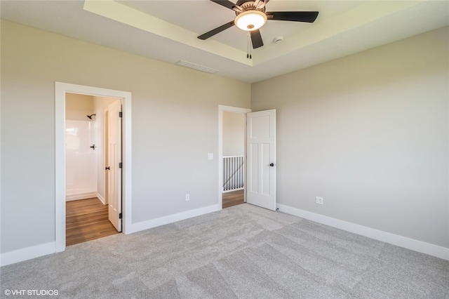 unfurnished bedroom featuring connected bathroom, ceiling fan, and light colored carpet