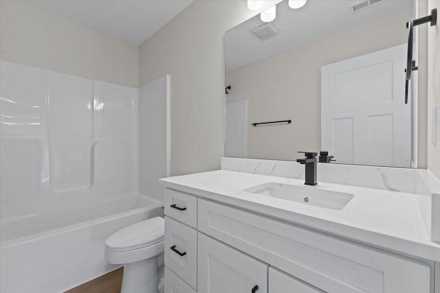 full bathroom featuring hardwood / wood-style flooring, shower / washtub combination, toilet, and vanity