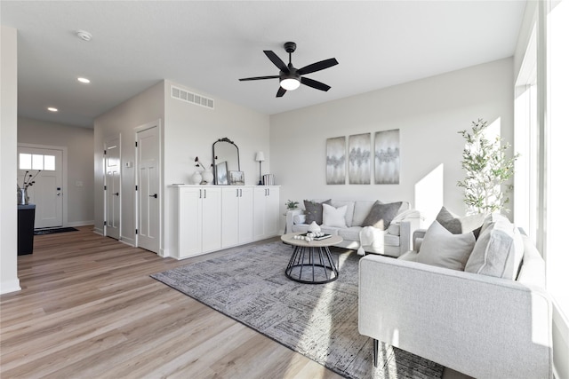 living room featuring ceiling fan and light hardwood / wood-style floors