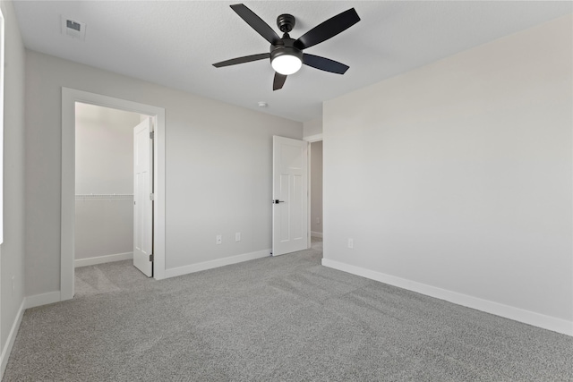 unfurnished bedroom featuring light colored carpet, ceiling fan, and a closet