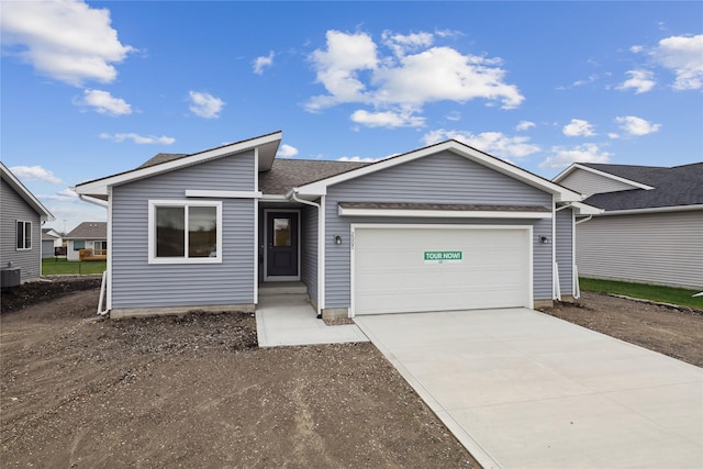 ranch-style house with a garage and central air condition unit