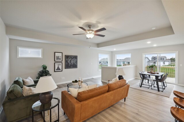 living room featuring ceiling fan and light wood-type flooring