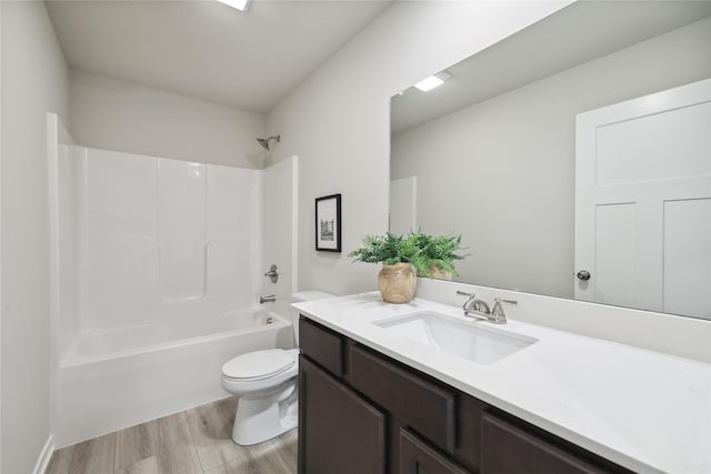 full bathroom with hardwood / wood-style flooring, vanity, toilet, and shower / washtub combination