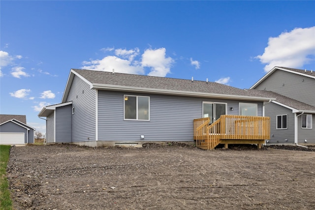 rear view of property featuring a deck