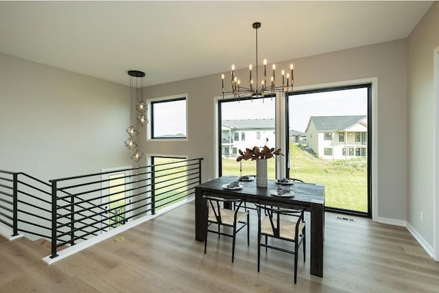 dining area featuring an inviting chandelier and hardwood / wood-style floors