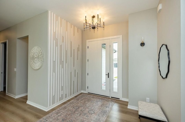 entrance foyer with wood-type flooring and a chandelier