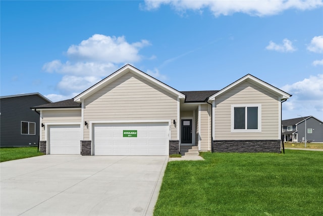 view of front of home with a front yard and a garage