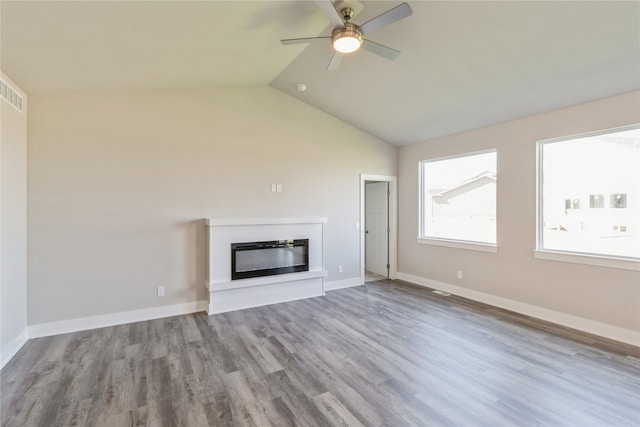 unfurnished living room with light hardwood / wood-style floors, ceiling fan, and vaulted ceiling