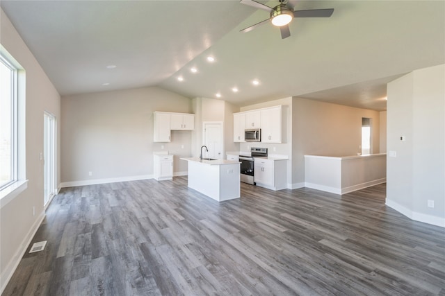 unfurnished living room with sink, ceiling fan, hardwood / wood-style flooring, and vaulted ceiling