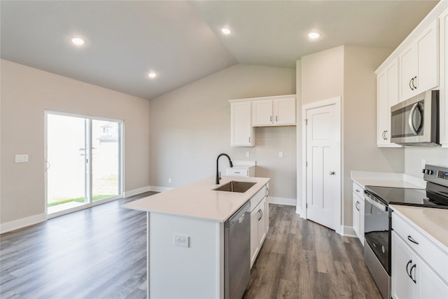 kitchen with an island with sink, stainless steel appliances, lofted ceiling, white cabinets, and dark wood-type flooring