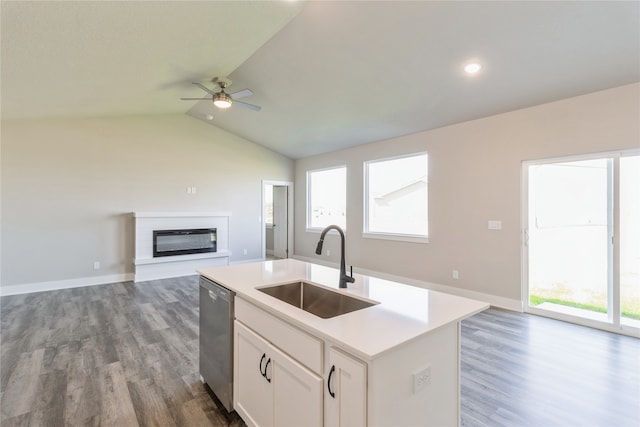 kitchen featuring a wealth of natural light, stainless steel dishwasher, sink, and white cabinets