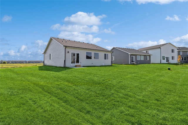 back of house with a lawn