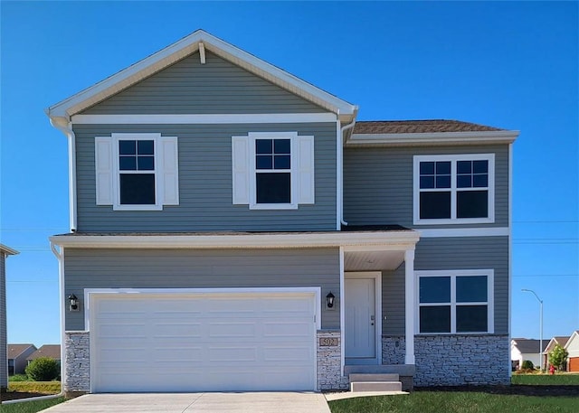 view of front of property with concrete driveway, an attached garage, and stone siding