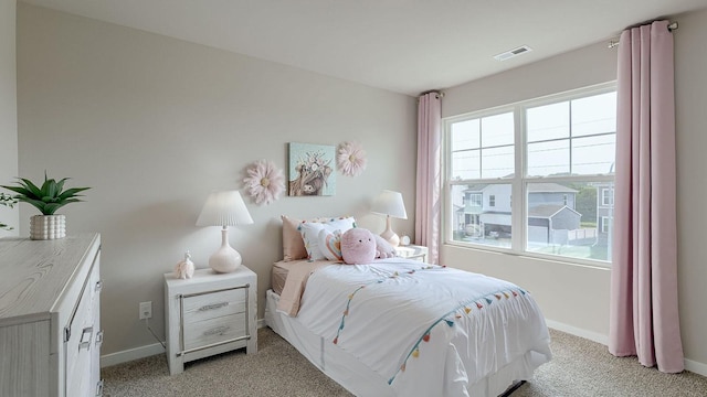 bedroom with visible vents, light colored carpet, and baseboards