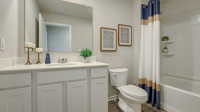 full bath with vanity, shower / bath combo with shower curtain, toilet, and visible vents