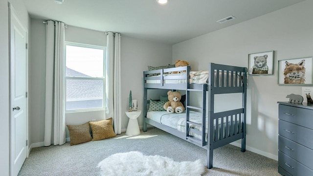 carpeted bedroom featuring visible vents and baseboards