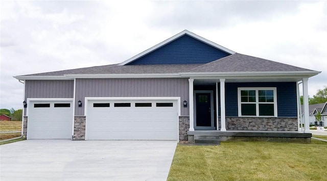 view of front of house with a front yard and a garage