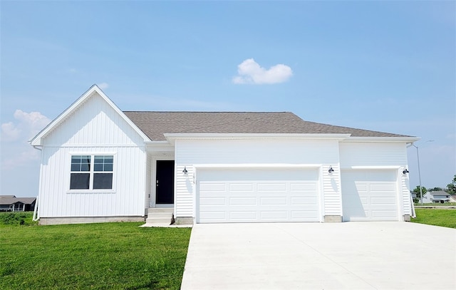 view of front of home featuring a garage and a front yard