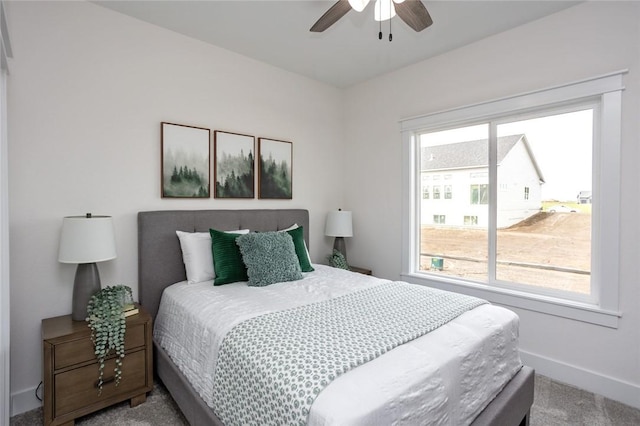 bedroom with multiple windows, carpet floors, and ceiling fan