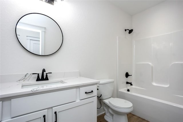 full bathroom with shower / tub combination, vanity, toilet, and hardwood / wood-style floors