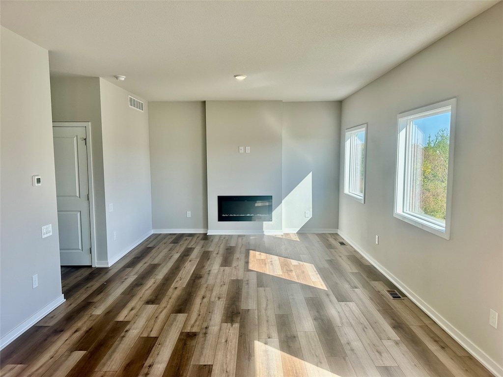 unfurnished living room featuring hardwood / wood-style flooring