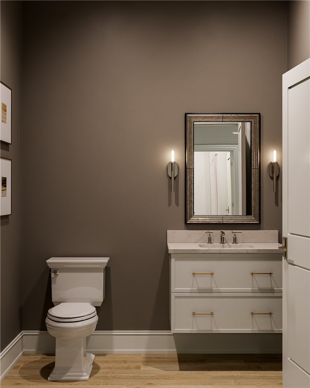 bathroom with vanity, hardwood / wood-style flooring, and toilet