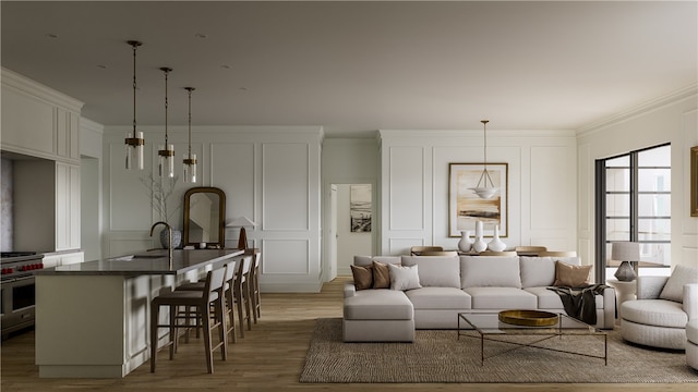 living room with sink, light wood-type flooring, and ornamental molding