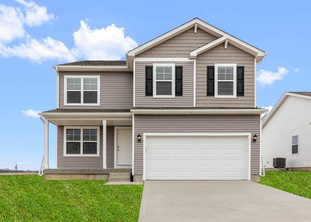 view of front of home with a front yard, a garage, and central AC