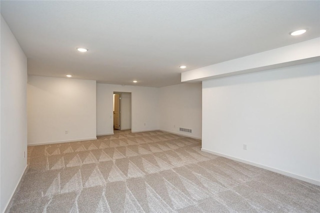 basement featuring light carpet