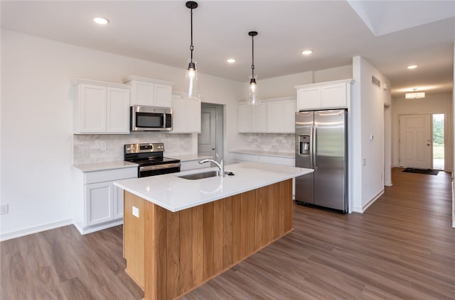 kitchen with sink, white cabinets, a center island with sink, and appliances with stainless steel finishes