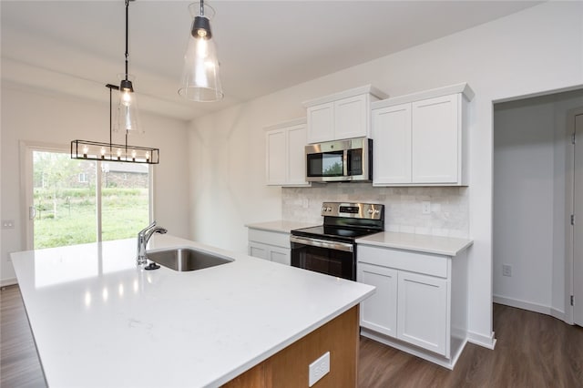 kitchen featuring hanging light fixtures, white cabinets, and stainless steel appliances