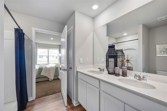 bathroom with a shower with shower curtain, toilet, hardwood / wood-style flooring, and vanity