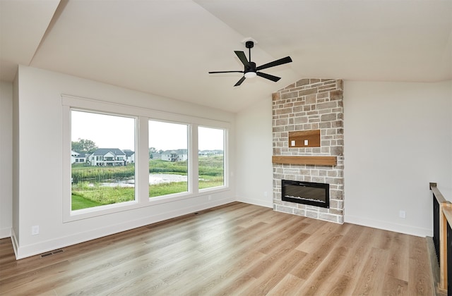 unfurnished living room with light wood-type flooring, a fireplace, lofted ceiling, and ceiling fan