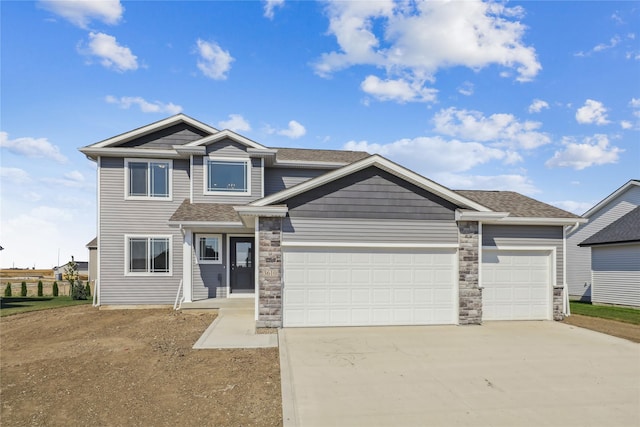 3610 NW 27th St, Ankeny, IA 50023 - view of front of property featuring concrete driveway, a garage, stone siding, and roof with shingles