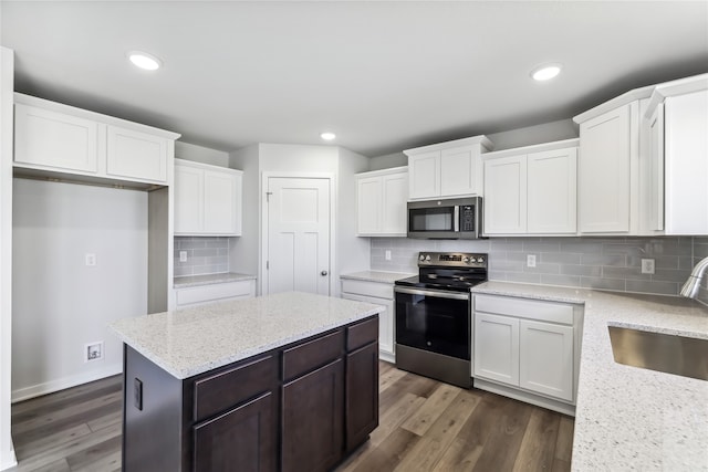 kitchen with white cabinets, sink, tasteful backsplash, dark wood-type flooring, and appliances with stainless steel finishes