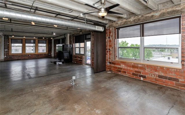 garage with ceiling fan and a wood stove