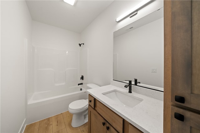 full bathroom with wood-type flooring, toilet, bathing tub / shower combination, and vanity