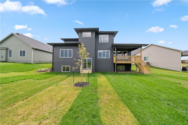 rear view of property with a wooden deck and a yard