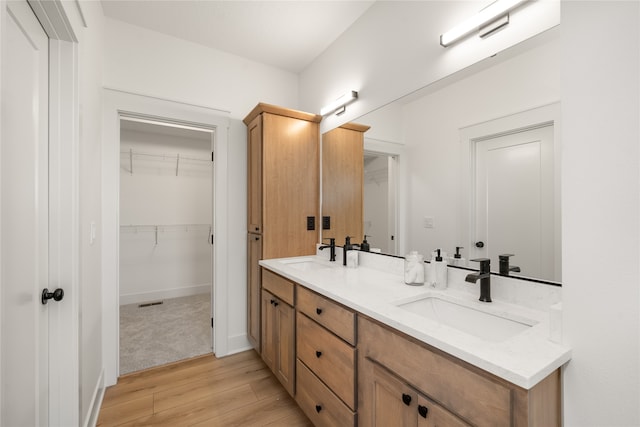 bathroom with vanity and hardwood / wood-style floors