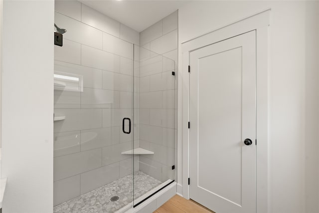 bathroom featuring a shower with shower door