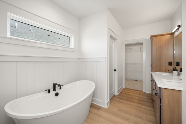 bathroom featuring vanity, a bathtub, and hardwood / wood-style floors