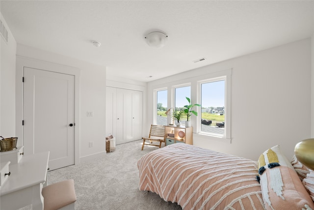 carpeted bedroom with a closet