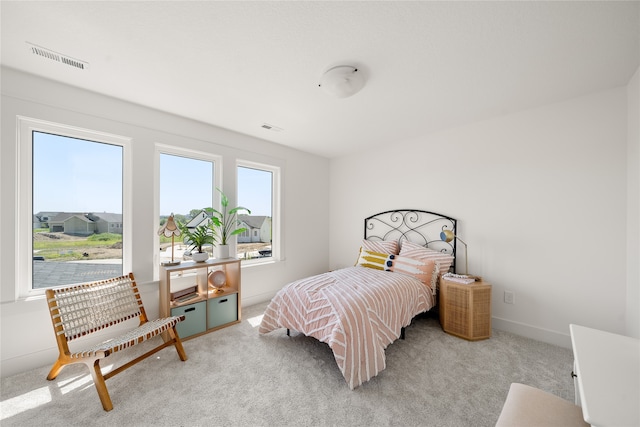 bedroom featuring light colored carpet