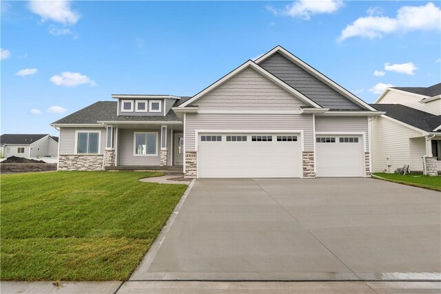 view of front facade with a garage and a front lawn